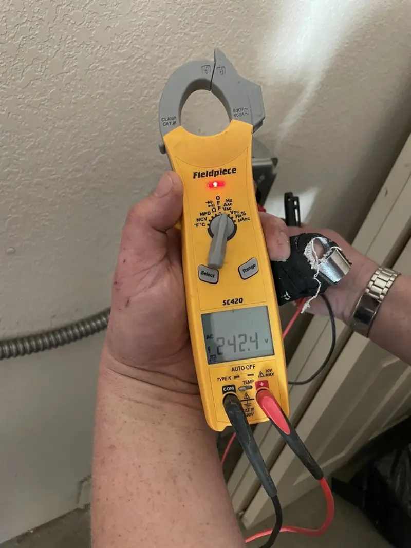Voltage testing with clamp meter during Ceiling Fan Installation in Gages Lake